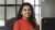 Person sat in office smiling at camera