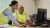 Two office workers working on a computer in high visibility vests