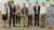 Eight people standing in a line indoors