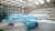 Blue and white British Airways passenger plane in aircraft hangar