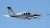 Propeller plane flying away from the viewer in a  blue sky