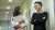 Two Malaysia graduates smiling in the hallway of the office