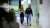 Man and woman walking through office