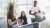 Three young people having an informal conversation in the office