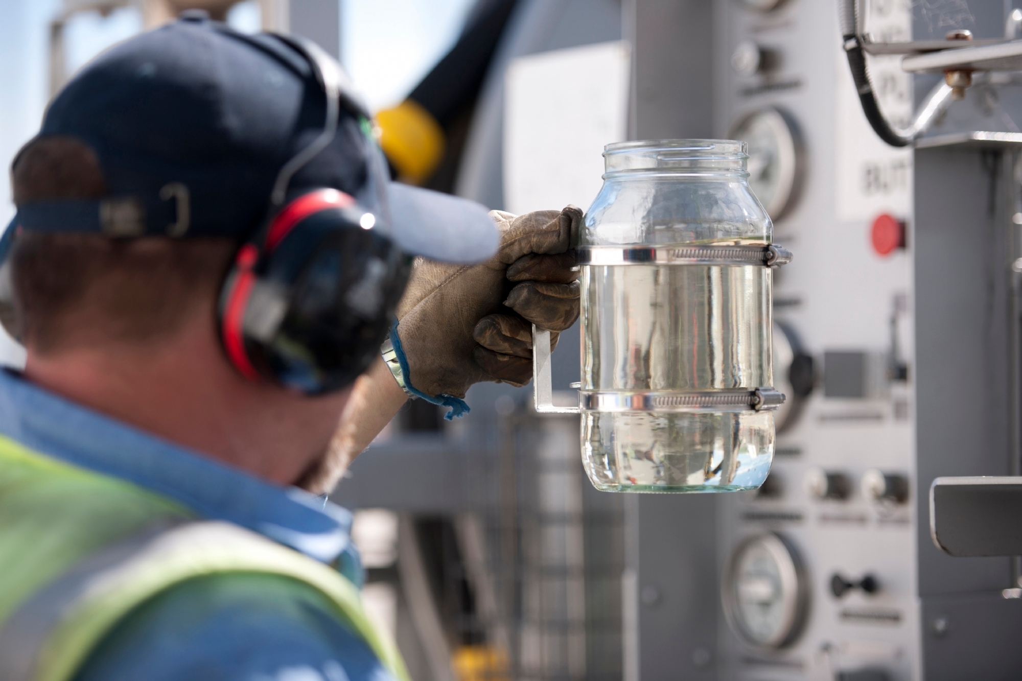 Rick Lewis conducts a quality control check of a sample of Jet A-1 aviation fuel, Brisbane Airport, Australia