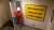 An operator walks through a doorway of a stairwell displaying a large safety sign on the wall on board BP's Shah Deniz Platform, which is located in t...