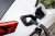 A close up of an electric vehicle plugged in and charging at a convenient public electric vehicle charging station in Newcastle upon Tyne in the North East of England.