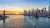 A picture of New York Harbor with a bridge in the middle and the city on the right side