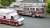 A red firetruck and ambulance parked side-by-side on the street